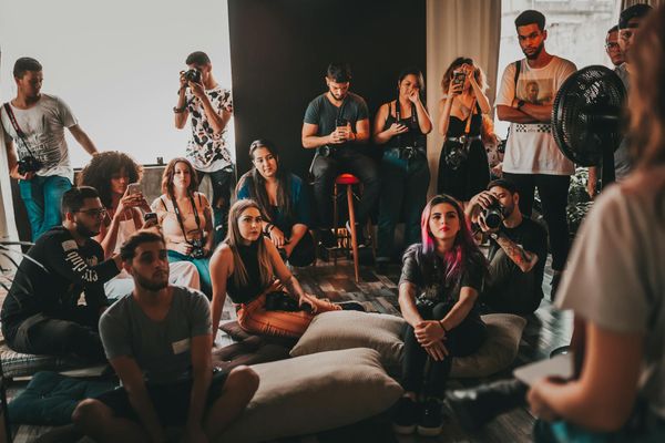 Group of diverse people practicing yoga together in a bright studio.